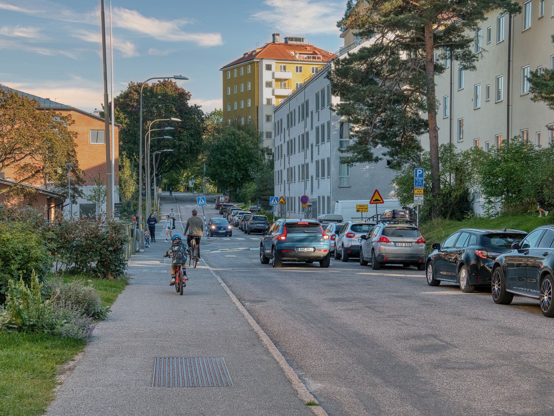 Bicycle ride on a bustling street in Stockholm with cars and pedestrians.