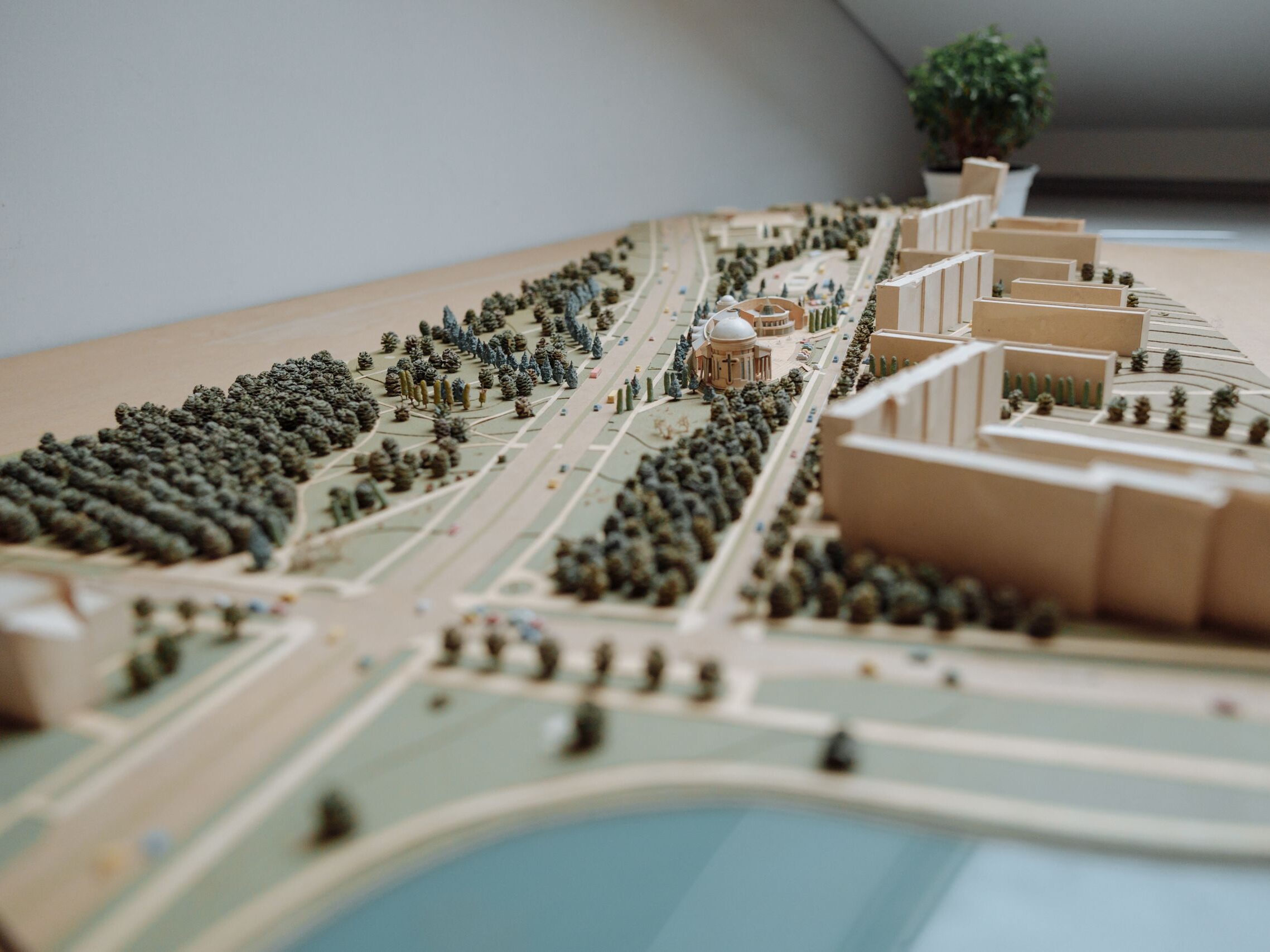 Close-up of an architectural miniature model depicting an urban layout with buildings, roads, and greenery.